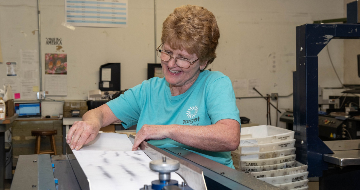 A woman prepares letters as part of direct mail advertising