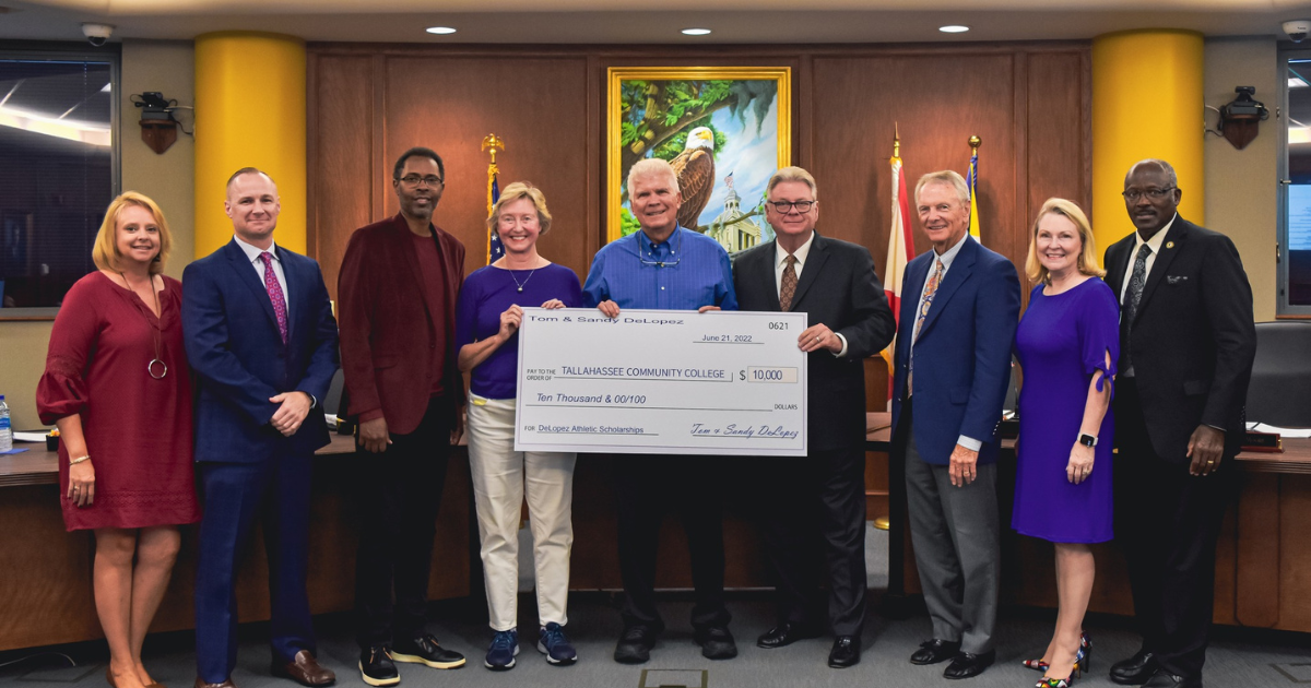 Group holding a giant check