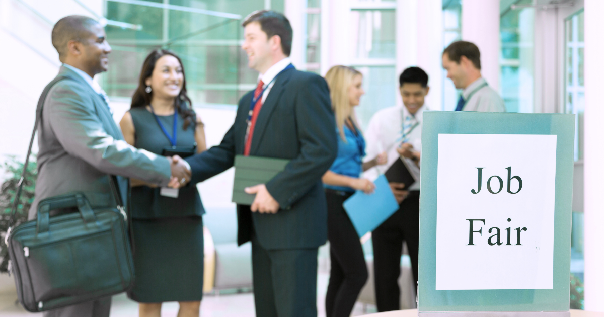 Professionals shaking hands at a job fair